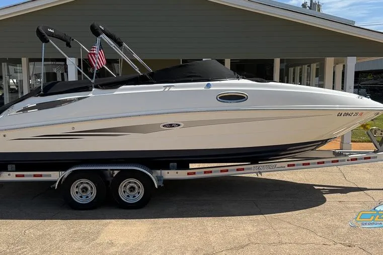 Slide: The Image of 2014 Sea Ray 260 Sundeck boat on trailer, parked outside a building. - 14