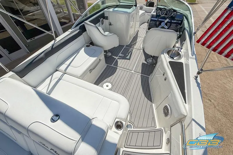 Slide: The Image of 2014 Sea Ray 260 Sundeck interior with white seating and modern dashboard. - 17