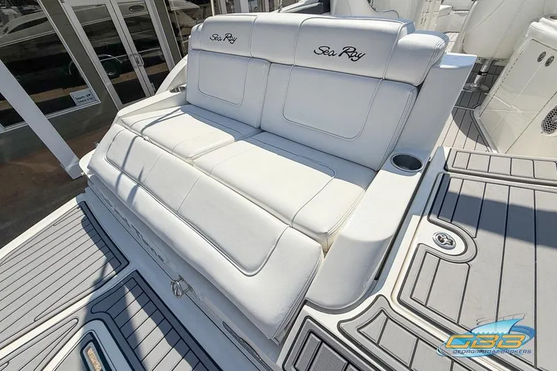 Slide: The Image of 2014 Sea Ray 260 Sundeck boat with white cushioned seating and sleek deck design. - 21