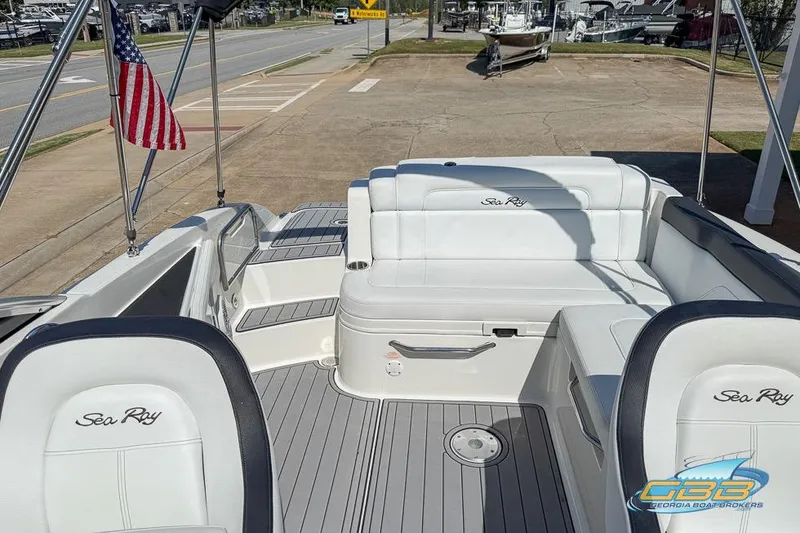 Slide: The Image of 2014 Sea Ray 260 Sundeck interior with white seating and American flag. - 22