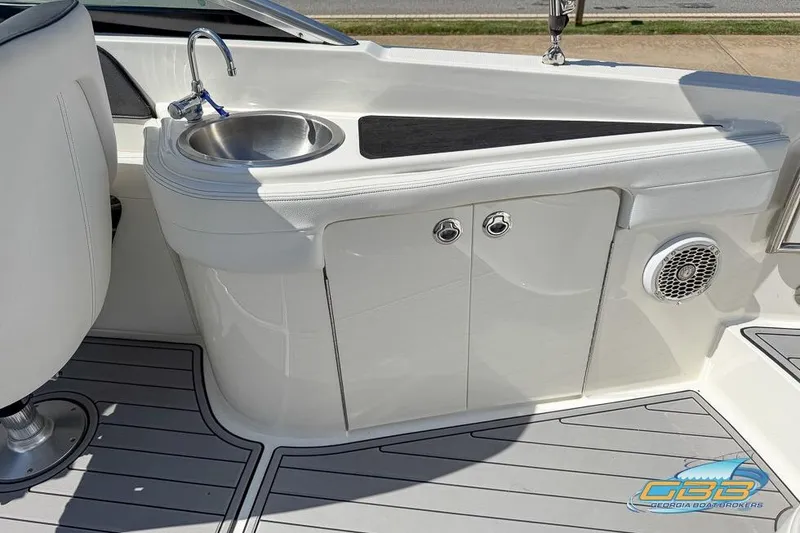 Slide: The Image of 2014 Sea Ray 260 Sundeck interior with sink, storage, and speaker on deck. - 26