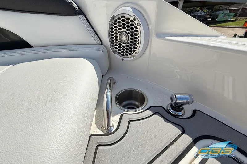 Slide: The Image of 2014 Sea Ray 260 Sundeck interior with speaker, cup holder, and chrome fittings. - 29