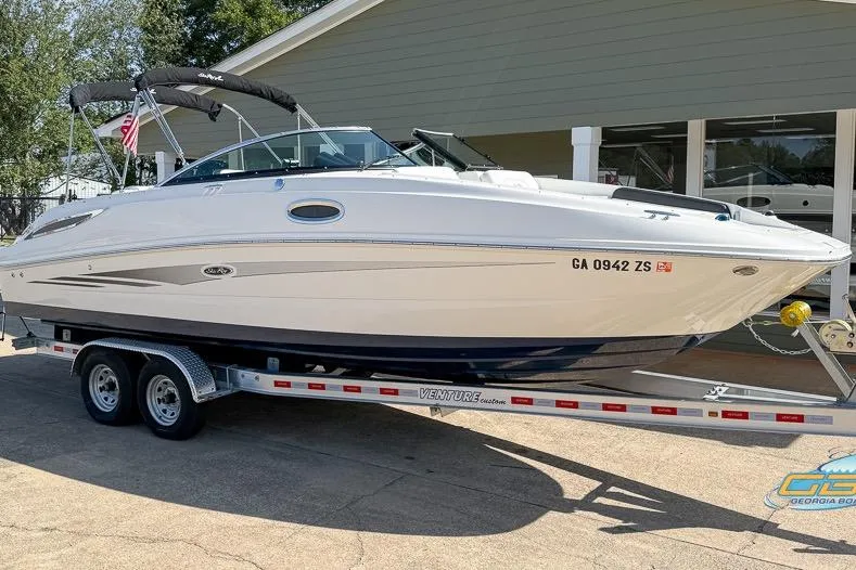 Slide: The Image of 2014 Sea Ray 260 Sundeck boat on trailer, parked outside a building. - 3