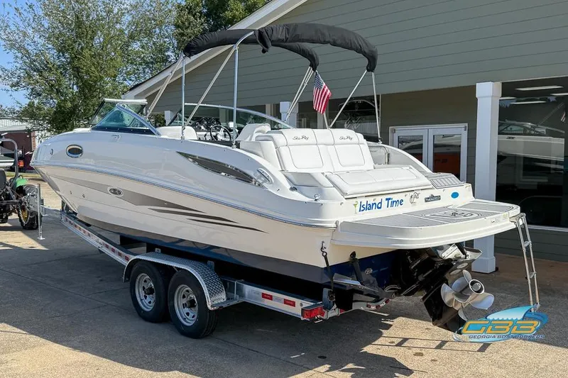 Slide: The Image of 2014 Sea Ray 260 Sundeck boat on trailer, parked outdoors near a building. - 7