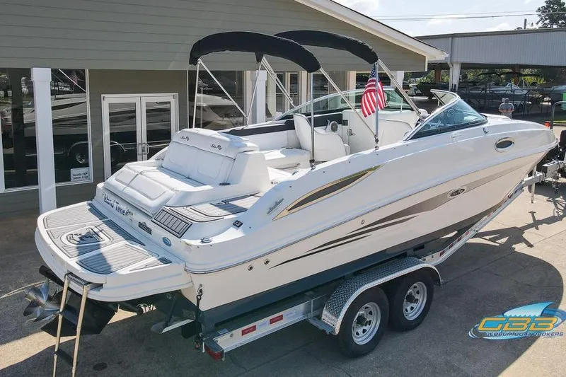 Slide: The Image of 2014 Sea Ray 260 Sundeck boat on trailer, displayed outdoors with American flag. - 8