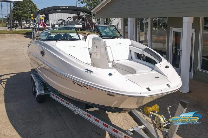 Slide: The Image of 2014 Sea Ray 260 Sundeck boat on trailer, parked outside a building. - 9