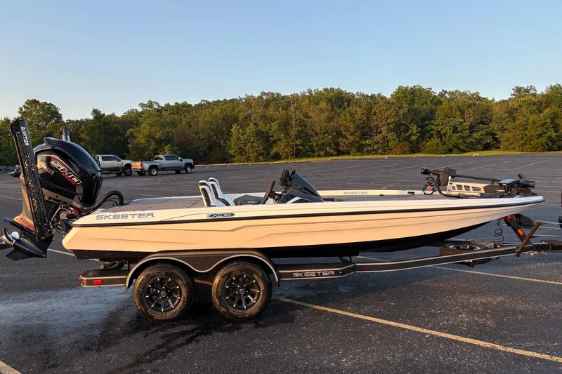 The Image of 2026 Skeeter ZXE20 boat on trailer in parking lot, surrounded by trees. - 0