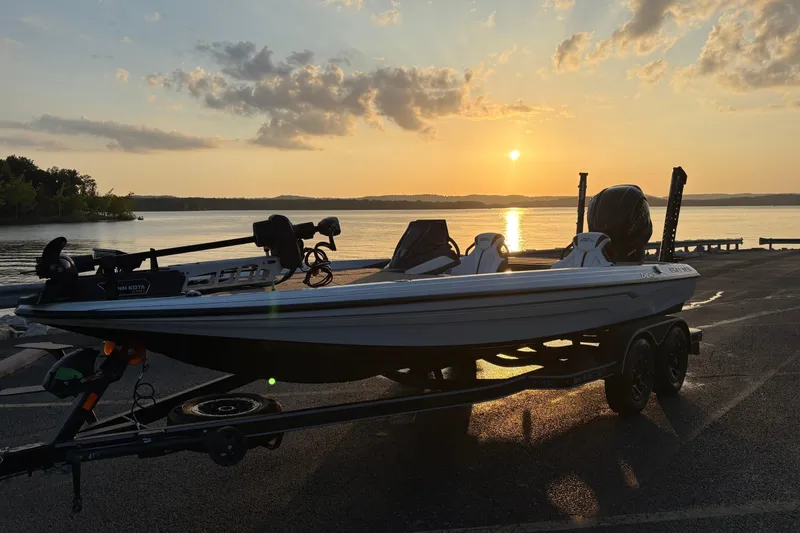 Slide: The Image of 2026 Skeeter ZXE20 boat at sunset by a serene lake. - 4