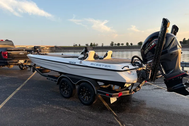 Slide: The Image of 2026 Skeeter ZXE20 boat on trailer by waterfront at sunset. - 5