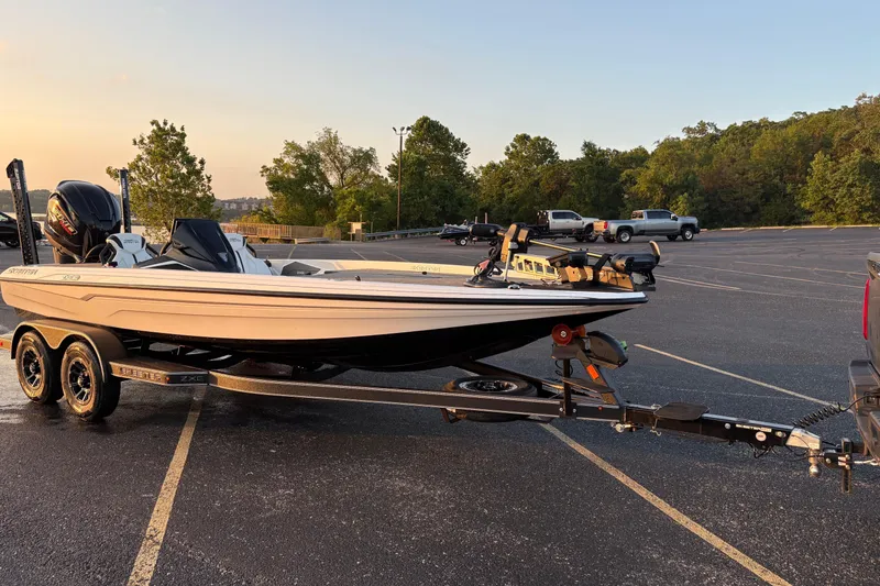 Slide: The Image of 2026 Skeeter ZXE20 boat on trailer in parking lot at sunset. - 7