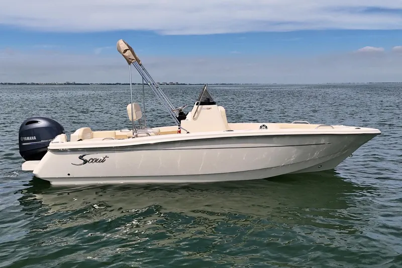 The Image of 2026 Scout 188 Sportfish boat on calm water with Yamaha outboard motor. - 0