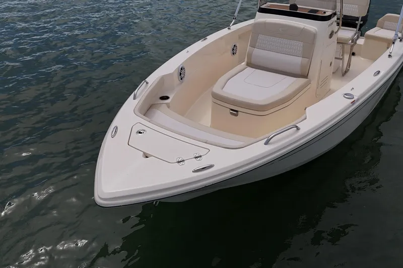 Slide: The Image of 2026 Scout 188 Sportfish boat on water, featuring sleek design and comfortable seating. - 10