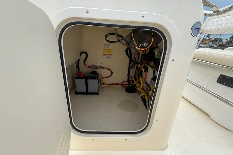 Slide: The Image of 2026 Scout 188 Sportfish boat compartment with battery and wiring. - 21