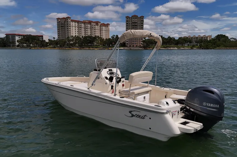 Slide: The Image of 2026 Scout 188 Sportfish boat on water with Yamaha engine, cityscape background. - 3
