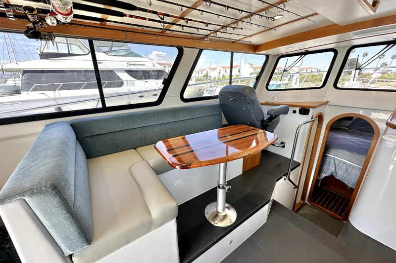 Slide: The Image of Interior of 2021 Lindell 42/46 boat with seating, helm, and mounted TV. - 12
