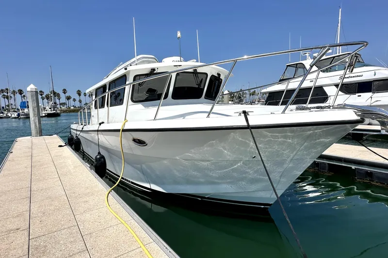Slide: The Image of 2021 Lindell 42/46 yacht docked at marina under clear blue sky. - 2