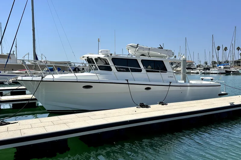 Slide: The Image of 2021 Lindell 42/46 boat docked at marina under clear blue sky. - 3