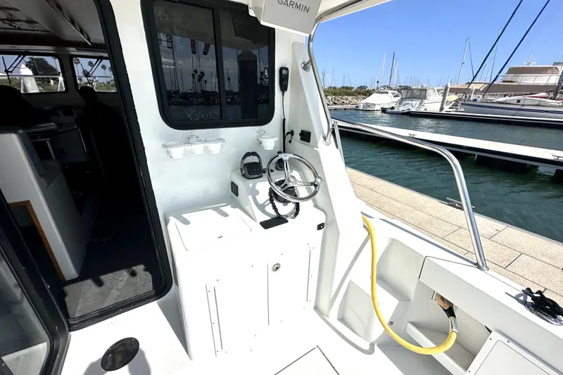 Slide: The Image of 2021 Lindell 42/46 boat deck with ocean view and marina in background. - 9