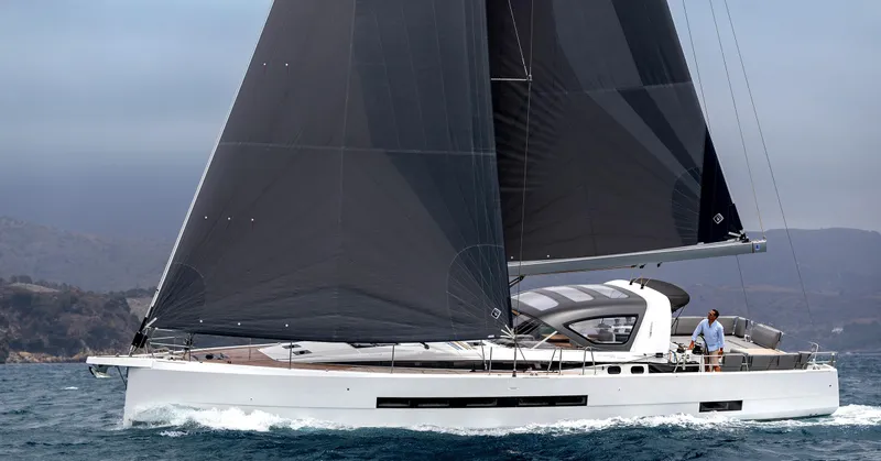 The Image of 2026 Jeanneau Yachts 55 sailing on open water with sleek design and dark sails. - 0