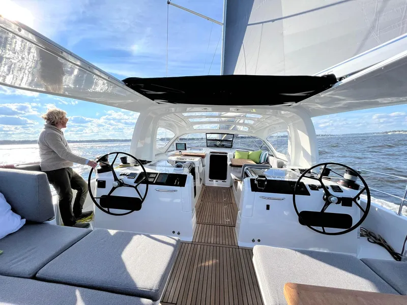 Slide: The Image of 2026 Jeanneau Yachts 55 sailing on open water, featuring dual steering wheels and spacious deck. - 1