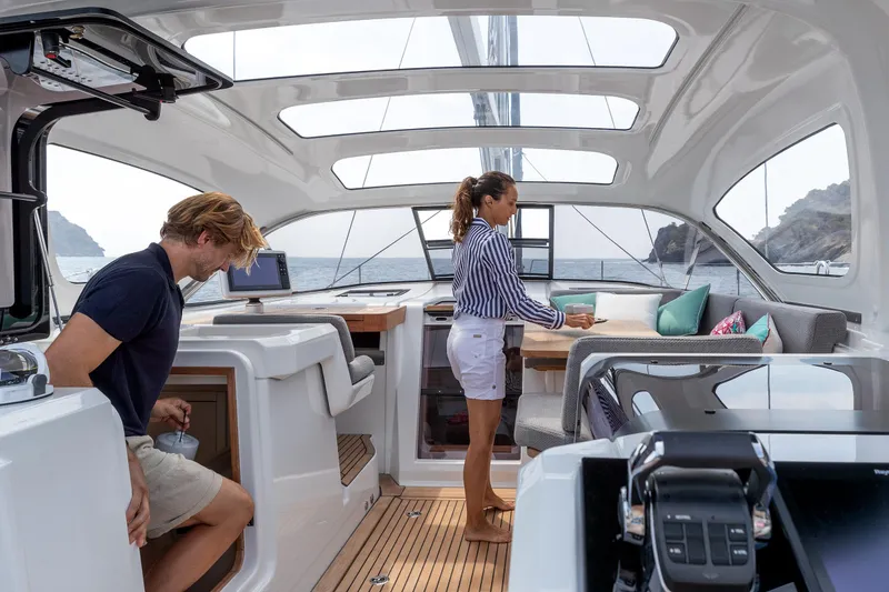Slide: The Image of 2026 Jeanneau Yachts 55 interior with people, featuring modern design and spacious seating. - 10
