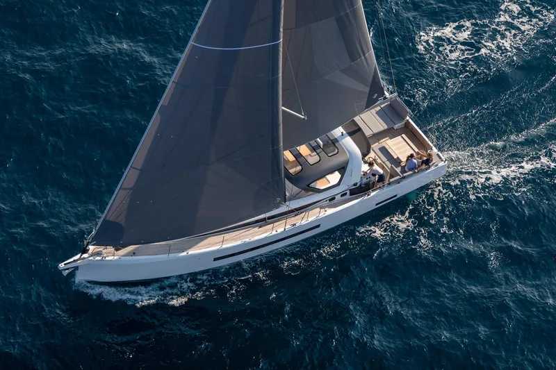 Slide: The Image of 2026 Jeanneau Yachts 55 sailing on open sea, aerial view. - 3