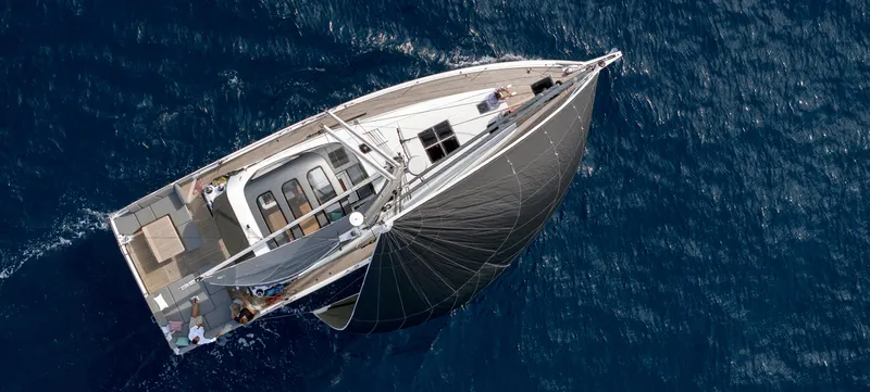 Slide: The Image of 2026 Jeanneau Yachts 55 sailing on open sea, aerial view. - 7