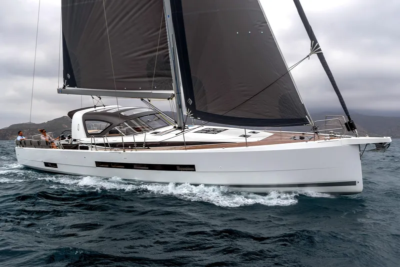Slide: The Image of 2026 Jeanneau Yachts 55 sailing on open water with sleek design and dark sails. - 8