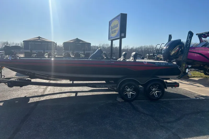 Slide: The Image of 2025 Skeeter ZXR21 boat on trailer in outdoor showroom. - 13