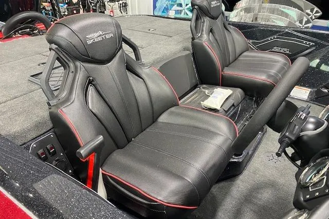 Slide: The Image of 2025 Skeeter ZXR21 boat interior with black leather seats and red accents. - 6