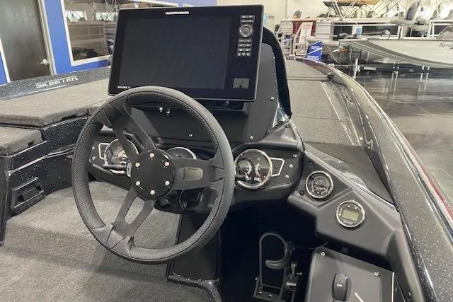 Slide: The Image of 2025 Skeeter ZXR21 boat dashboard with steering wheel and electronic display. - 7