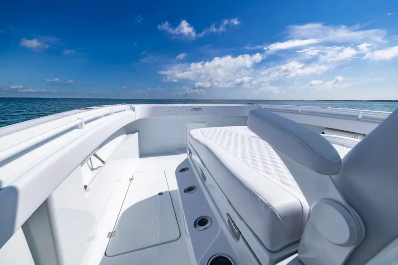 Slide: The Image of 2026 Invincible 33 Catamaran with luxurious seating, cruising on a clear blue ocean. - 16
