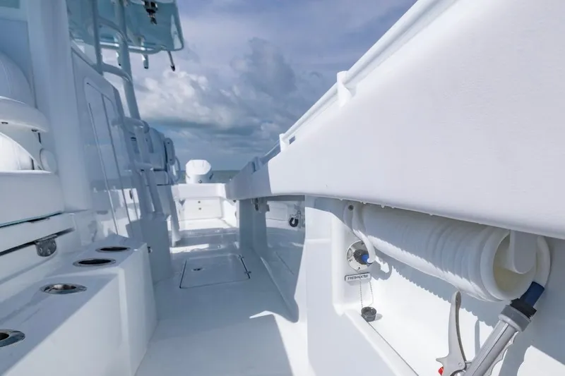 Slide: The Image of Invincible 33 Catamaran 2026 interior deck view with modern features and clear sky. - 18