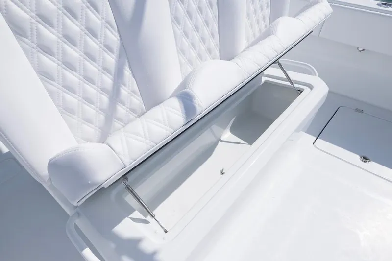 Slide: The Image of White cushioned seating with storage on 2026 Invincible 33 Catamaran boat. - 31