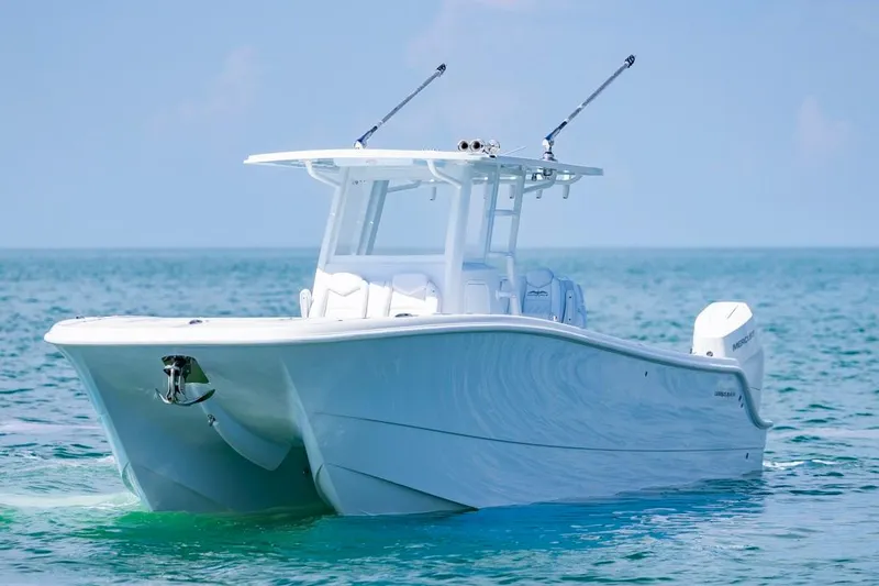 Slide: The Image of 2026 Invincible 33 Catamaran on calm ocean waters, showcasing sleek design and modern features. - 4