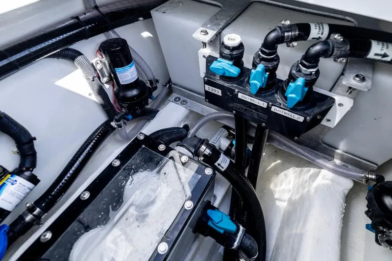 Slide: The Image of 2026 Invincible 33 Catamaran engine compartment with detailed plumbing and wiring systems. - 41