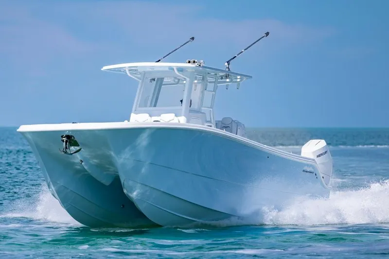 Slide: The Image of Invincible 33 Catamaran 2026 cruising on open water, showcasing sleek design and performance. - 6