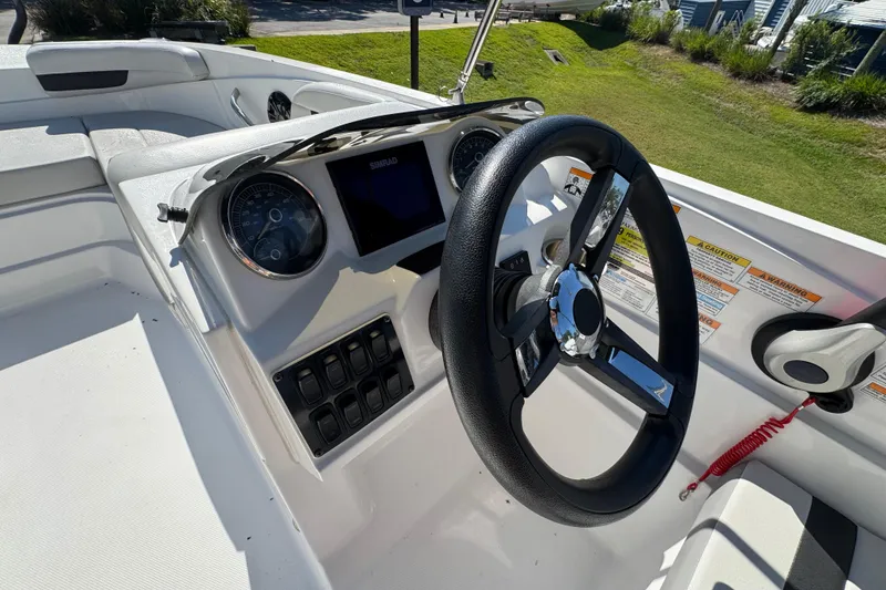 Slide: The Image of 2021 Hurricane SunDeck Sport 185 OB boat dashboard with steering wheel and controls. - 5