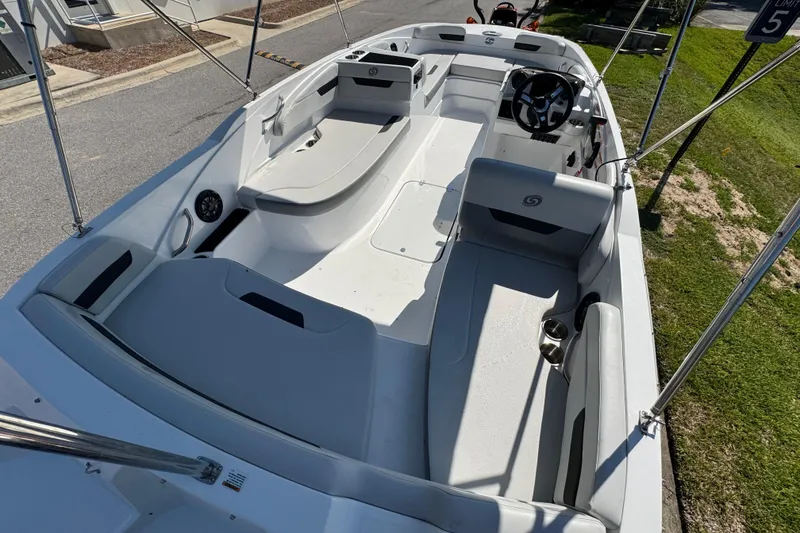 Slide: The Image of 2021 Hurricane SunDeck Sport 185 OB boat interior with seating and steering wheel. - 7
