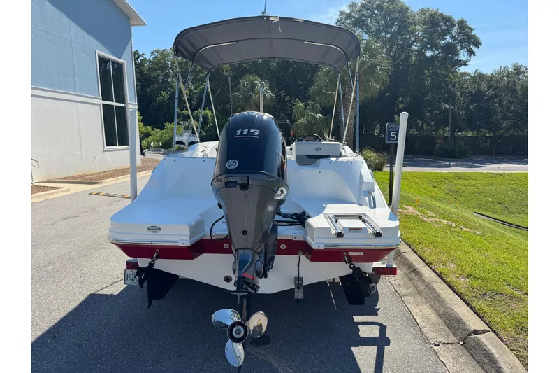 Slide: The Image of 2021 Hurricane SunDeck Sport 185 OB boat with outboard motor, parked outdoors. - 9