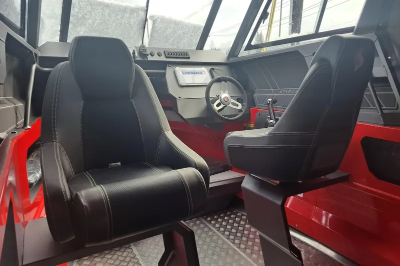 Slide: The Image of 2024 Stabicraft 2050 Supercab Sportfisher interior with black seats and steering console. - 3
