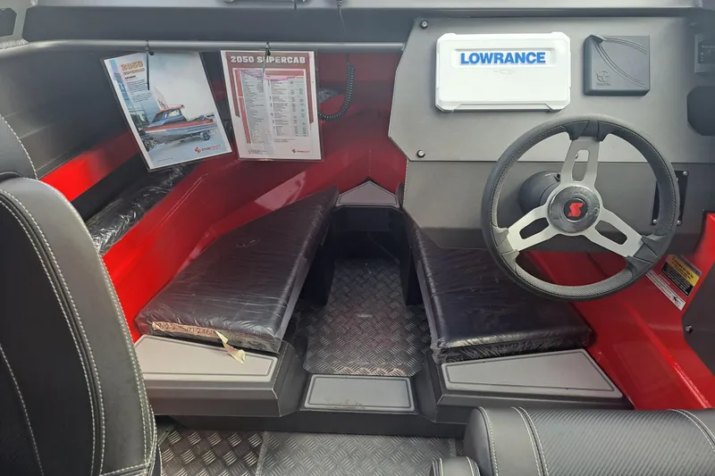 Slide: The Image of 2024 Stabicraft 2050 Supercab Sportfisher interior with steering wheel and navigation system. - 4