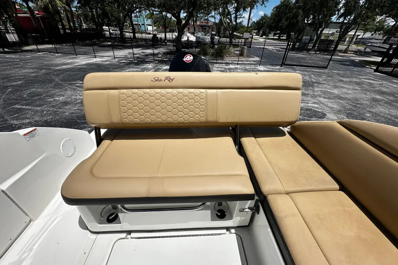 Slide: The Image of 2023 Sea Ray SDX 250 Outboard boat with tan leather seating in a sunny outdoor setting. - 10