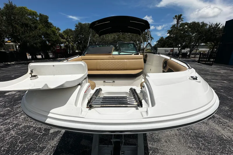 Slide: The Image of 2023 Sea Ray SDX 250 Outboard boat with open bow seating and swim ladder. - 12