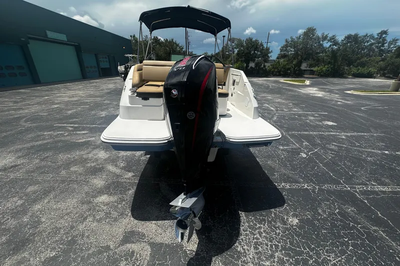 Slide: The Image of 2023 Sea Ray SDX 250 Outboard boat, rear view with outboard motor, parked outdoors. - 2