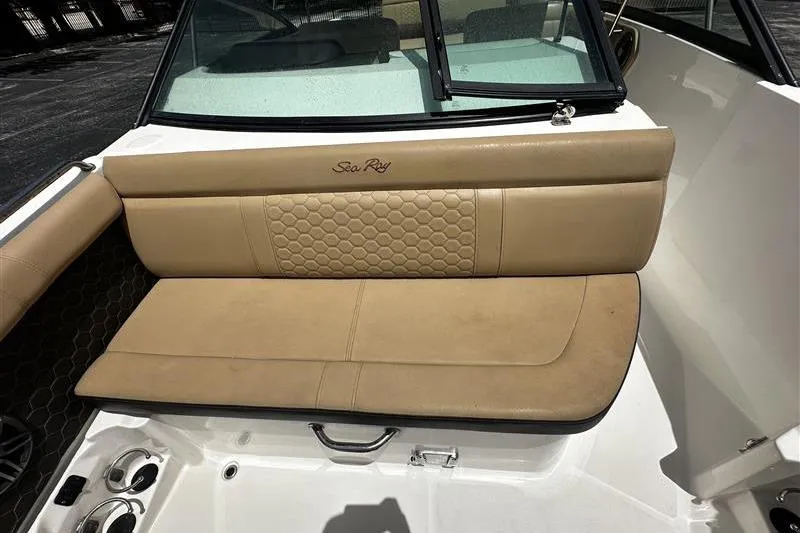 Slide: The Image of 2023 Sea Ray SDX 250 Outboard boat interior with tan seating and cup holders. - 3