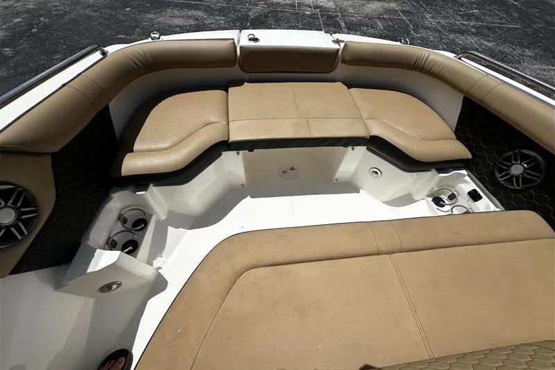 Slide: The Image of 2023 Sea Ray SDX 250 Outboard boat interior with tan seating and cup holders. - 4