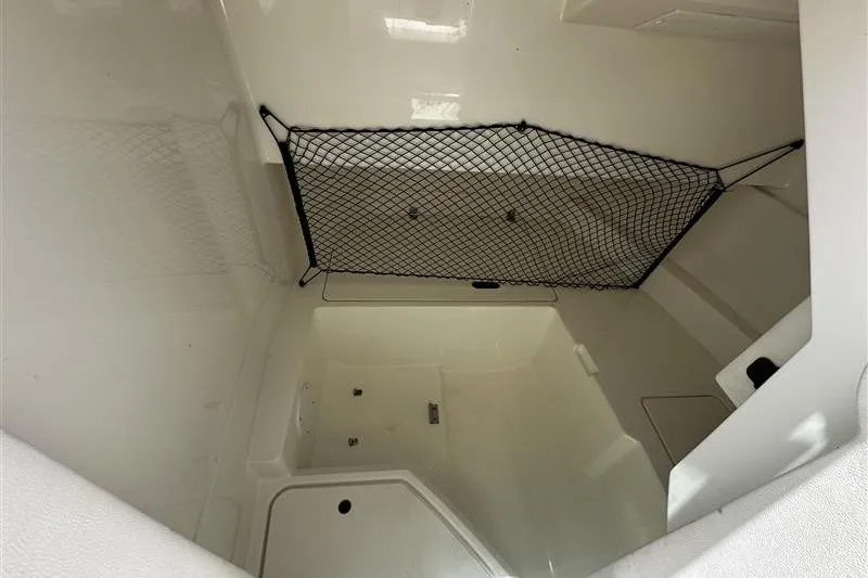 Slide: The Image of 2023 Sea Ray SDX 250 Outboard storage compartment with netting. - 6