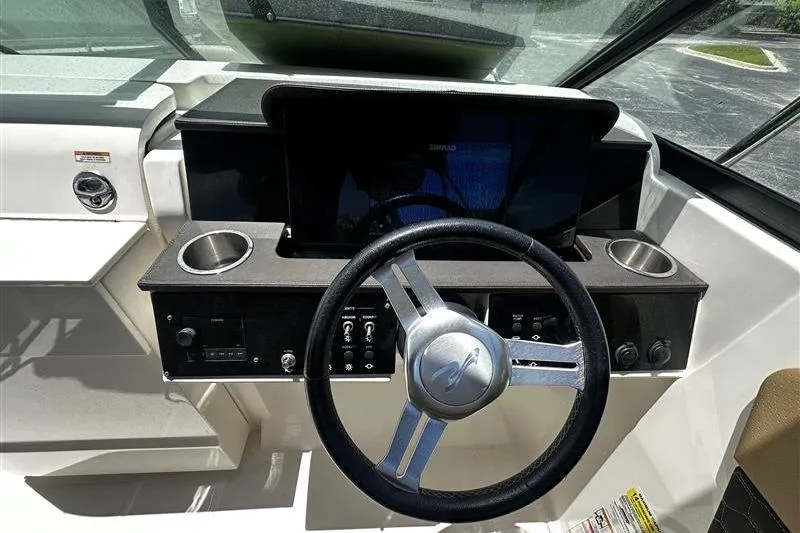 Slide: The Image of 2023 Sea Ray SDX 250 Outboard boat dashboard with steering wheel and controls. - 8