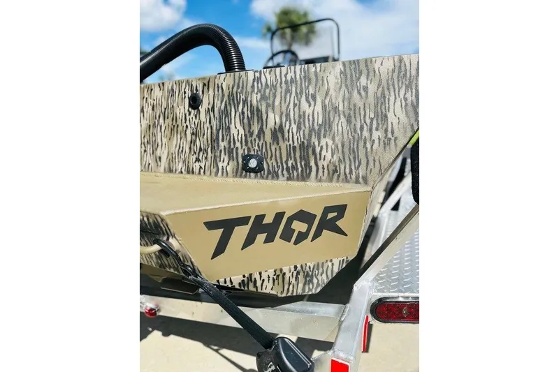Slide: The Image of 2025 Thor 1900 Lake Hammer boat with camouflage design and bold logo. - 10